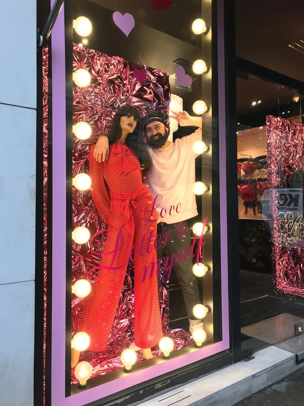 Juan Carlos Barrón inside a Valentine’s Day window he has just set up