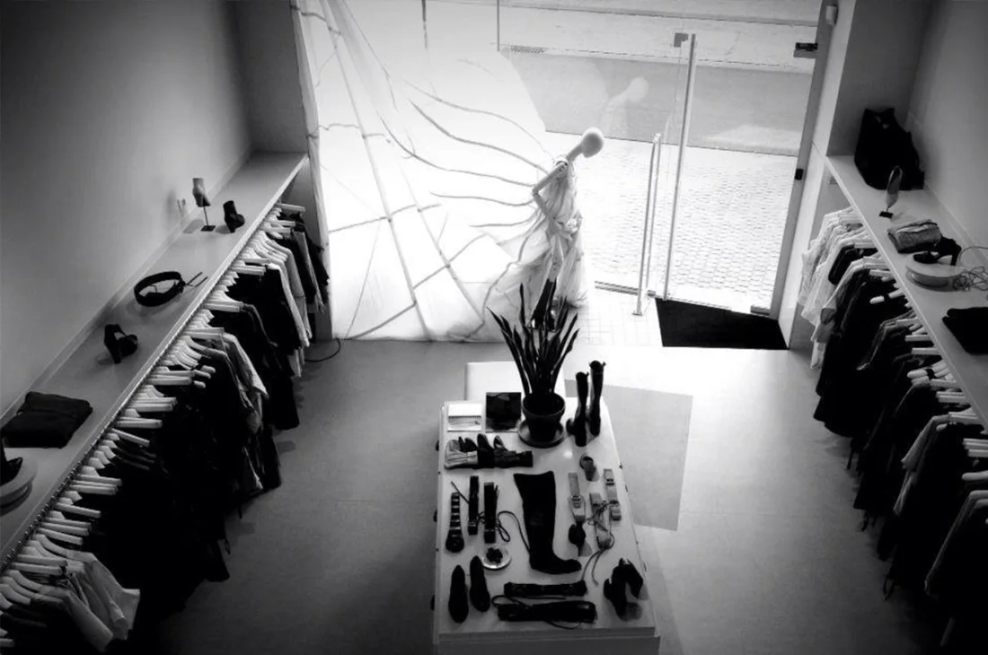 Interior de tienda de moda con escaparate y mesa de producto